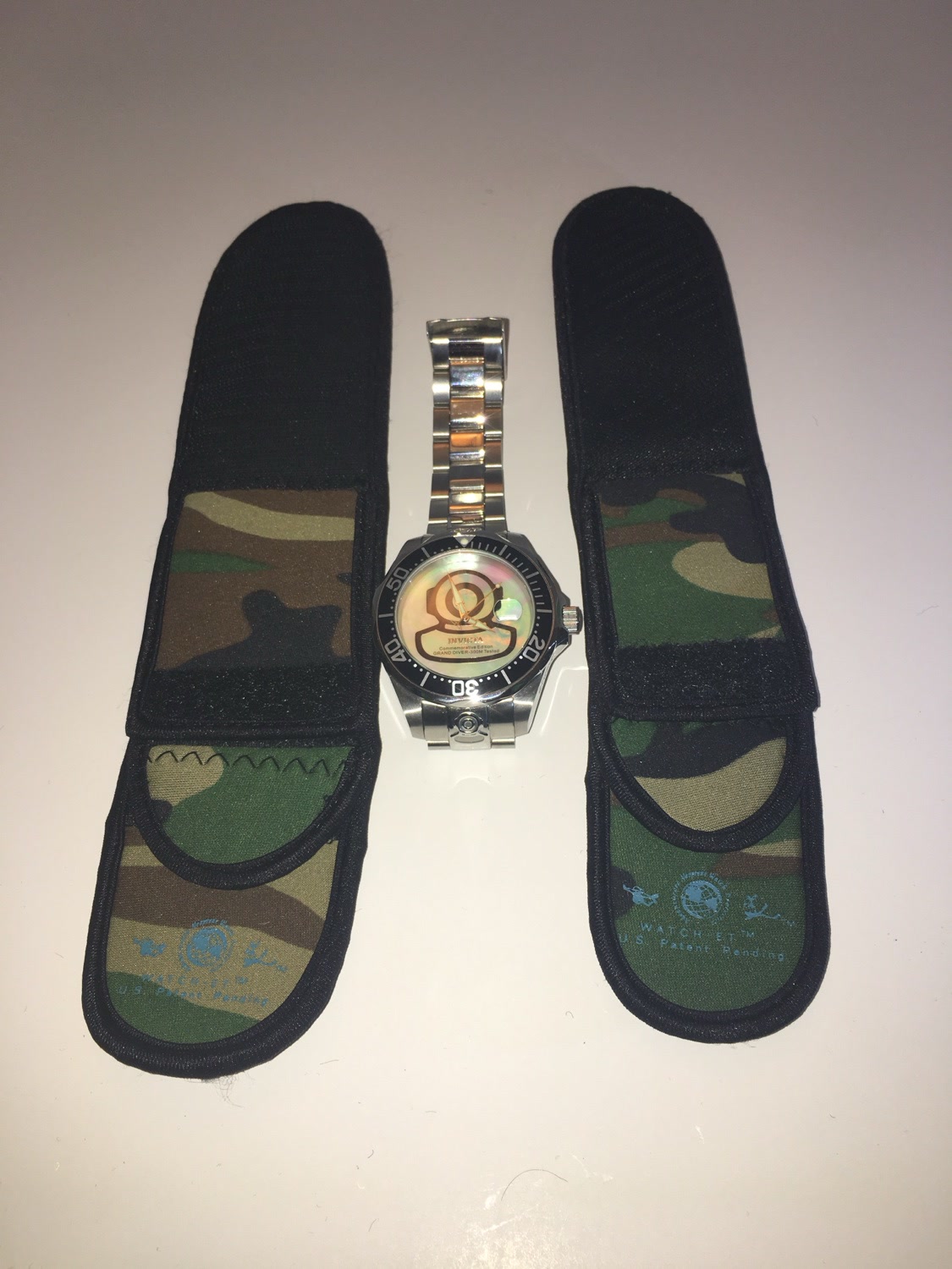 Two Camo WATCH-ET sleeves flanking an Invicta dive watch